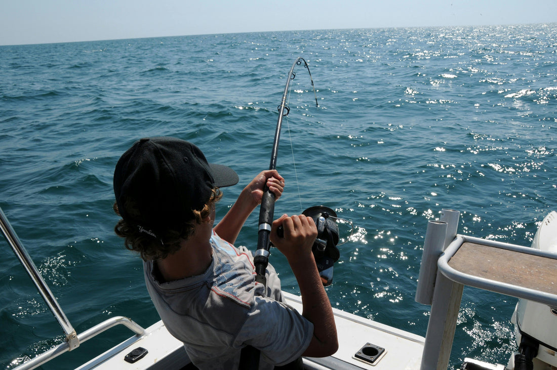 Man fishing off a boat